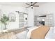 Bright main bedroom showcasing barn door access to a ensuite bath, white walls, and wood floors at 5814 Cole Way, Arvada, CO 80004