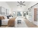 Spacious bedroom with a sitting area, a ceiling fan, and a barn door entrance at 5814 Cole Way, Arvada, CO 80004