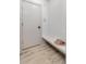 An entryway featuring a bench, wooden floors, and clean white walls to transition from outside to inside at 5814 Cole Way, Arvada, CO 80004