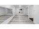 Finished basement with laminate flooring, mirrored wall, and bathroom entry at 17 E Belleview Ln, Greenwood Village, CO 80121