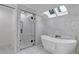 Bright bathroom with skylights, free-standing tub, and glass enclosed shower at 17 E Belleview Ln, Greenwood Village, CO 80121