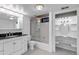 Renovated bathroom features a shower-tub combination, vanity, and a separate make-up vanity at 17 E Belleview Ln, Greenwood Village, CO 80121
