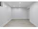 Bright, minimalist bedroom with recessed lighting, baseboard trim, and vinyl plank flooring at 17 E Belleview Ln, Greenwood Village, CO 80121