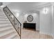Elegant entryway features stairs with wrought iron railings, leading to a light-filled home at 17 E Belleview Ln, Greenwood Village, CO 80121