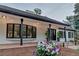 Attractive home featuring black-trimmed windows, brick accents, and manicured landscaping at 17 E Belleview Ln, Greenwood Village, CO 80121