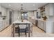 Modern kitchen with large island, stainless steel appliances, and stylish pendant lighting at 17 E Belleview Ln, Greenwood Village, CO 80121