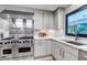 Kitchen featuring stainless steel Viking range and hood with white cabinets and countertops at 17 E Belleview Ln, Greenwood Village, CO 80121