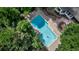 Beautiful pool with blue water surrounded by lush greenery at 17 E Belleview Ln, Greenwood Village, CO 80121