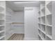 Spacious walk-in closet with custom shelving and hanging rods, providing ample storage space at 17 E Belleview Ln, Greenwood Village, CO 80121