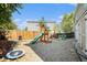 The backyard has a playset, mini trampoline, grill, and gravel at 20604 E 38Th Pl, Denver, CO 80249