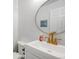 Bright and modern bathroom featuring a white vanity, toilet, and decorative mirror at 20604 E 38Th Pl, Denver, CO 80249