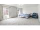 Bright bedroom features plush carpeting, large windows, and a comfortable queen-sized bed at 20604 E 38Th Pl, Denver, CO 80249