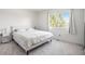 Bright bedroom featuring a queen bed, bedside tables with lamps, and a sunlit window at 20604 E 38Th Pl, Denver, CO 80249