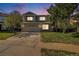 Charming two-story home with a well-maintained lawn, mature trees, and a two-car garage at 20604 E 38Th Pl, Denver, CO 80249
