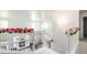 Bright hallway with stairs, decorated with pink flowers, and open view into the home at 20604 E 38Th Pl, Denver, CO 80249