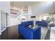 Open living space with tall ceilings, staircase, and contemporary blue furniture at 20604 E 38Th Pl, Denver, CO 80249