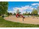 Community playground with multiple slides, climbing structures, swings, and soft landing surfaces at 20604 E 38Th Pl, Denver, CO 80249