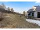 Large backyard with a hillside setting and well-maintained landscaping and stone retaining wall at 4788 Silver Pine Dr, Castle Rock, CO 80108
