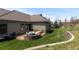 Well-maintained backyard featuring a stone-enclosed seating area and a terraced garden space at 4788 Silver Pine Dr, Castle Rock, CO 80108