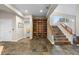 Finished basement with stone floors, built-in shelving, staircase, and ample natural light at 4788 Silver Pine Dr, Castle Rock, CO 80108