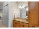 Bathroom featuring a vanity with a stone countertop and wood cabinetry, plus a large mirror at 4788 Silver Pine Dr, Castle Rock, CO 80108