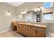 Well-lit bathroom showcasing double sinks, granite countertops, and ample storage in a functional and stylish design at 4788 Silver Pine Dr, Castle Rock, CO 80108