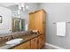 Bathroom vanity with granite countertop, wooden cabinets, and updated fixtures at 4788 Silver Pine Dr, Castle Rock, CO 80108