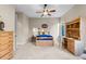 Well-lit bedroom featuring a bed with blue bedding, a desk, and ample storage with a dresser at 4788 Silver Pine Dr, Castle Rock, CO 80108