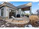 Exterior of home showing stone patio, outdoor seating, barbecue and architectural features at 4788 Silver Pine Dr, Castle Rock, CO 80108