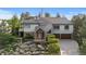 Beautiful two-story home featuring a stone accents, a two-car garage and professionally landscaped front yard at 4788 Silver Pine Dr, Castle Rock, CO 80108