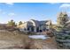 Beautiful home with a backyard patio, lush landscaping, and architectural details at 4788 Silver Pine Dr, Castle Rock, CO 80108