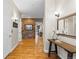 Hallway with hardwood floors, stylish wall decor, and a view into adjacent rooms at 4788 Silver Pine Dr, Castle Rock, CO 80108