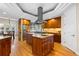 Spacious kitchen features an island cooktop, wooden cabinets, and stainless appliances at 4788 Silver Pine Dr, Castle Rock, CO 80108