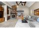 Spacious living room with a stone fireplace and seamless access to the dining area at 4788 Silver Pine Dr, Castle Rock, CO 80108