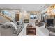Open living room with a fireplace, neutral furnishings, and large windows with views at 4788 Silver Pine Dr, Castle Rock, CO 80108