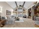 Bright living room featuring vaulted ceilings, large windows, neutral decor, and seamless access to the outdoor patio at 4788 Silver Pine Dr, Castle Rock, CO 80108