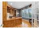 Stylish home office with custom built-ins, wood floors, and abundant natural light streaming through the window at 4788 Silver Pine Dr, Castle Rock, CO 80108