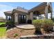 Back patio with flagstone tile, a covered area, and lush landscaping at 4788 Silver Pine Dr, Castle Rock, CO 80108