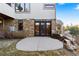 Outdoor patio with stone accents and large glass doors leading into the home at 4788 Silver Pine Dr, Castle Rock, CO 80108