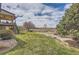 Manicured backyard featuring mature landscaping and stone pathway at 6340 Ashburn Ln, Highlands Ranch, CO 80130