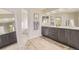 Bathroom featuring double vanity sinks, elegant lighting, and hardwood-style flooring at 6340 Ashburn Ln, Highlands Ranch, CO 80130