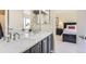 Well-lit bathroom with double sinks, modern fixtures, and a view into the bedroom at 6340 Ashburn Ln, Highlands Ranch, CO 80130