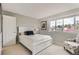 Bedroom with a neutral color palette, a cozy seating area, and a bright window view at 6340 Ashburn Ln, Highlands Ranch, CO 80130