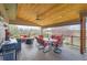 Spacious covered patio with outdoor seating, dining table, and ceiling fan at 6340 Ashburn Ln, Highlands Ranch, CO 80130