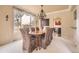 Elegant dining room with a large window, chandelier, and seating for eight at 6340 Ashburn Ln, Highlands Ranch, CO 80130
