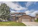 Charming two-story home with brick accents and well-manicured lawn at 6340 Ashburn Ln, Highlands Ranch, CO 80130