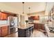 Well-appointed kitchen featuring a central island, stainless appliances, and wood cabinetry at 6340 Ashburn Ln, Highlands Ranch, CO 80130