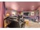 Spacious theater room with reclining leather seats and wall-mounted TV at 6340 Ashburn Ln, Highlands Ranch, CO 80130