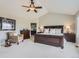 Spacious primary bedroom with vaulted ceiling, neutral decor, and comfortable sitting area at 6340 Ashburn Ln, Highlands Ranch, CO 80130