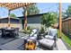 Cozy backyard patio features a fire pit, pergola, dining table and chairs plus lounge furniture at 3149 W 35Th Ave, Denver, CO 80211